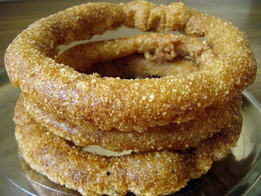 A stack of golden sel roti rice rings